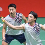 Malaysian men's doubles pair Goh Sze Fei and Nur Izzuddin Rumsani in action on the badminton court, mid-rally during their Thomas Cup match against Finland.