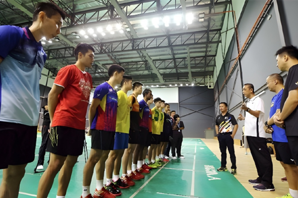 Malaysian national team players listen to coach during intensive training session