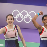 Uber Cup 2026 Campaign stars Pearly Tan and M Thinaah celebrating a win in front of the Olympic rings.