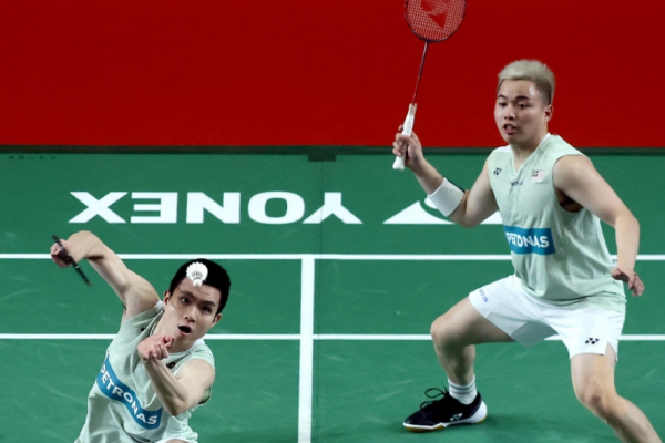 Malaysia Masters 2026 featuring Aaron and Wooi Yik in a high-stakes doubles rally.
