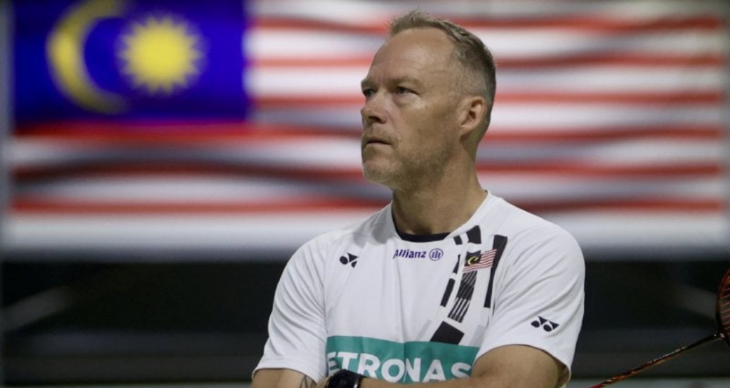 Malaysia Men Singles coach Kenneth Jonassen with the Malaysian flag.