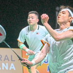 Close-up of Aaron Chia and Soh Wooi Yik in their official Malaysia team jerseys, looking focused and determined on the badminton court during the Thomas Cup 2026.
