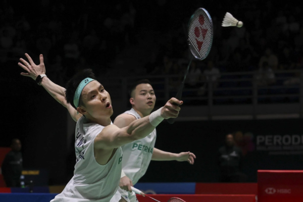 BWF World Rankings Shift context featuring Aaron Chia and Soh Wooi Yik defending a low shot.