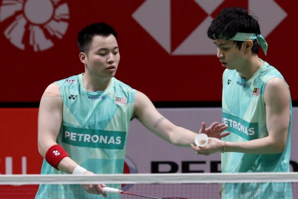 BWF Japan Open Reshuffle context showing Aaron Chia and Soh Wooi Yik during a match.