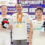 Asian Junior Championships title celebration featuring Ahmad Redzuan Low Zi Yu and coach Hazwan Jamaluddin.