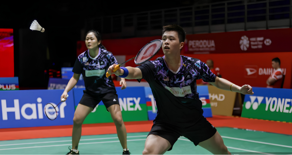 Tien Ci-Chiew Sien Promotion showing Wong Tien Ci lunging forward to play a shot with Lim Chiew Sien watching in the background.