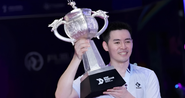 June Wei Taiwan Open showing Cheam June Wei holding the giant silver Lin Dan Cup trophy after his victory.