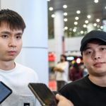 Aaron-Wooi Yik Exit showing Soh Wooi Yik and Aaron Chia speaking to reporters at KLIA.
