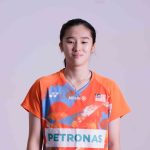 Eng Ler Qi professional badminton profile image showing the Malaysian singles player posing in an orange Petronas jersey against a white background.