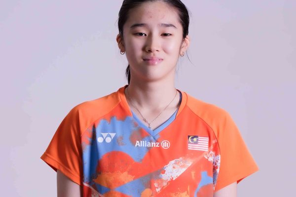 Eng Ler Qi professional badminton profile image showing the Malaysian singles player posing in an orange Petronas jersey against a white background.