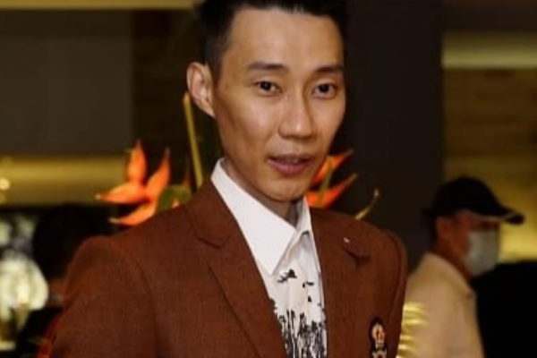 Lee Chong Wei professional badminton profile image showing the legendary Malaysian badminton icon posing in a brown suit.