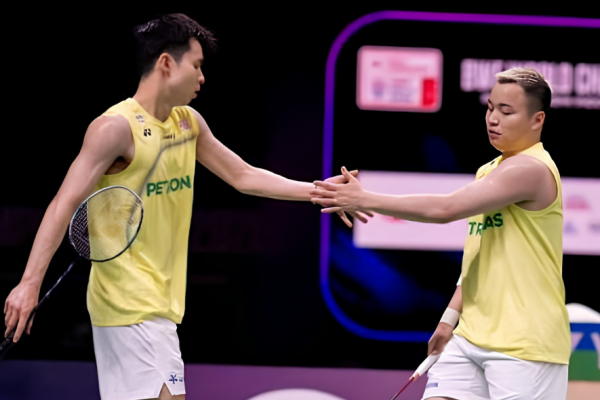 Aaron-Wooi Yik Future showing Aaron Chia and Soh Wooi Yik touching hands on the green court.