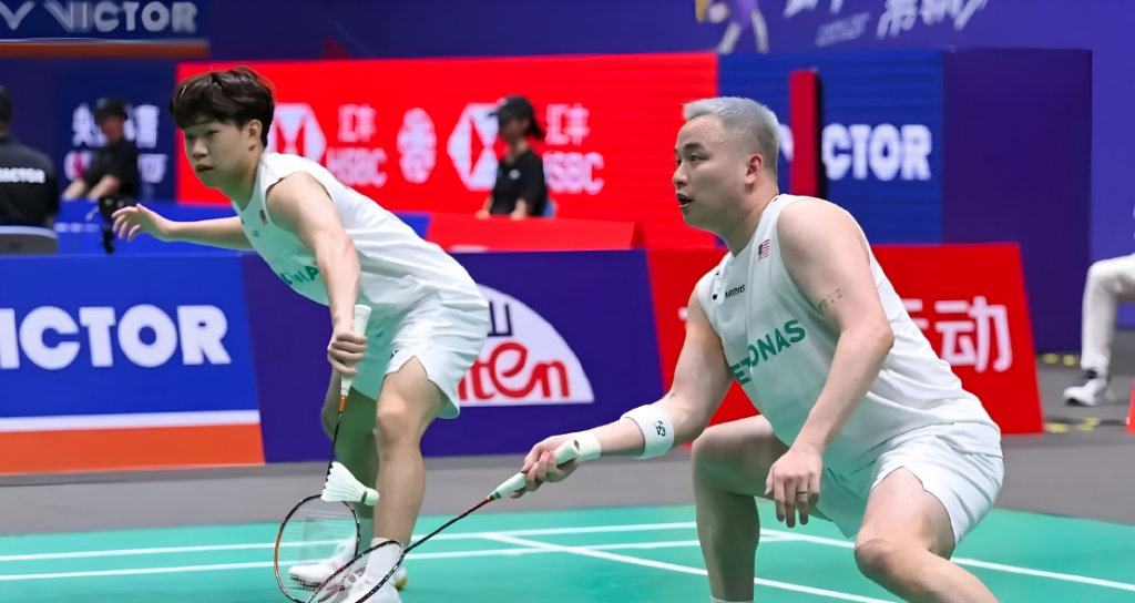 Aaron Chia Scratch Partnership showing Aaron Tai and Aaron Chia in action on the green court.