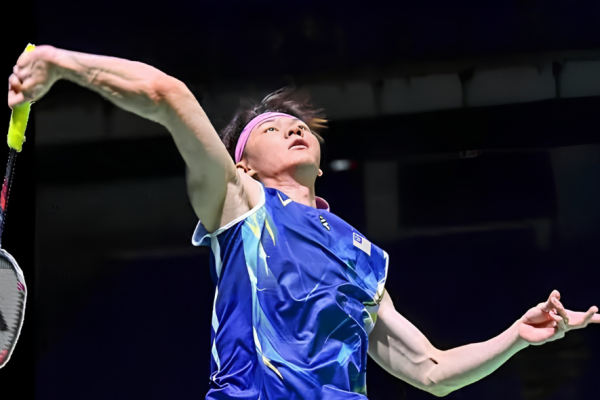 Zii Jia Korea Masters showing Lee Zii Jia executing a high jump smash on the green court.