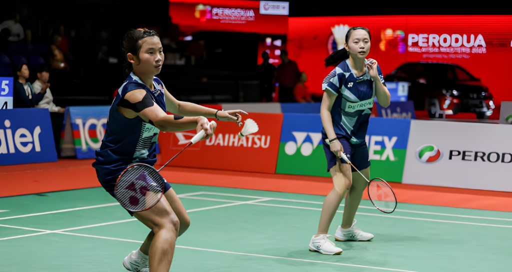 Carmen Ting and Ong Xin Yee competing on the green court.