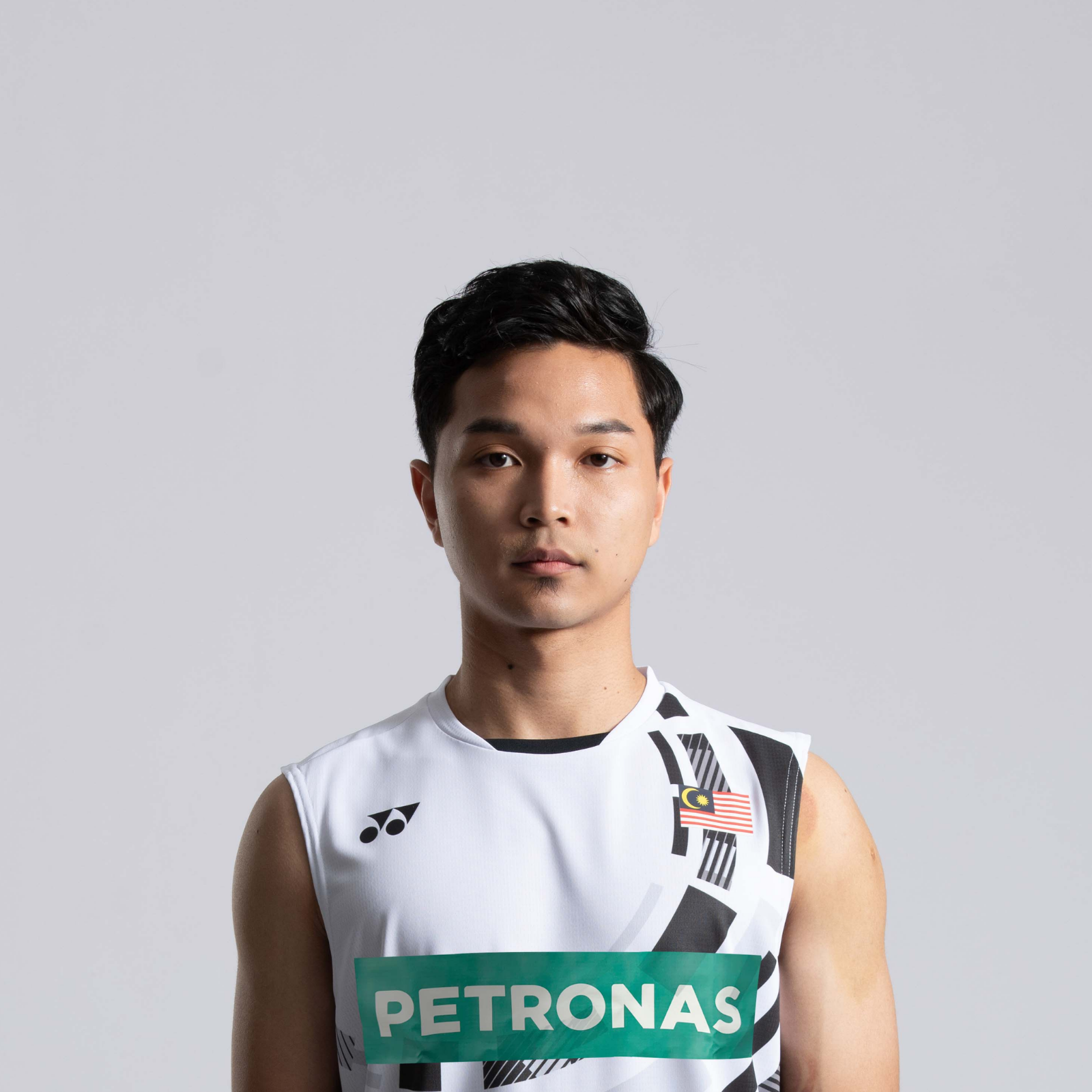 Wan Arif Wan Junaidi professional badminton profile image showing the Malaysian Men's Double player smiling