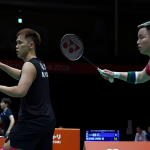 Aaron Chia and Tee Kai Wun raise their rackets in ready position during their Asian Games men's doubles match.