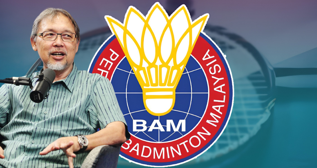 Razif Sidek speaks into a microphone during an interview beside the Badminton Association of Malaysia logo.