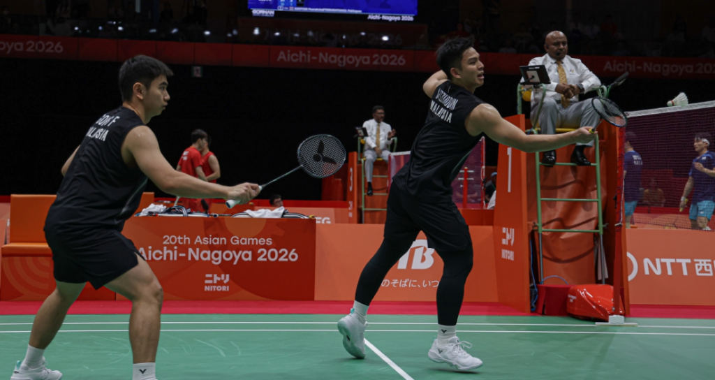 Nur Izzuddin Rumsani executes a forehand net tap while Goh Sze Fei stays ready during the Asian Games men's doubles match.