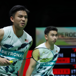 Goh Sze Fei and Nur Izzuddin Rumsani prepare to return a shot in their white Petronas Malaysian national jerseys during an international badminton match.