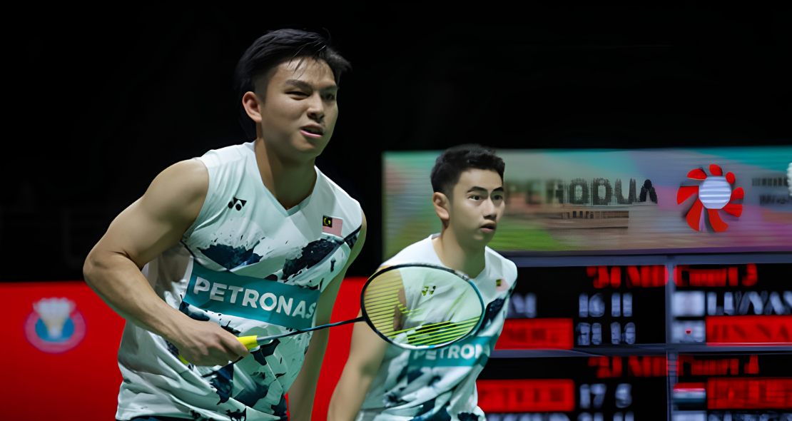 Goh Sze Fei and Nur Izzuddin Rumsani prepare to return a shot in their white Petronas Malaysian national jerseys during an international badminton match.