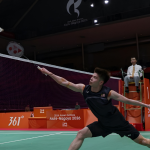 Leong Jun Hao executes a low net reach against Jonatan Christie during their Asian Games men's singles match.