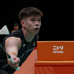 Leong Jun Hao lunges low to play a forehand net shot in his black Malaysian jersey during the Asian Games.