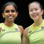 M. Thinaah and Pearly Tan smile and celebrate with fist pumps in their lime green Malaysian jerseys during the Asian Games.