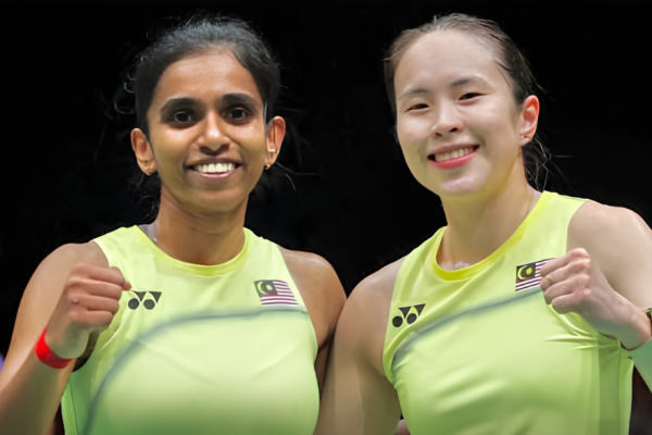M. Thinaah and Pearly Tan smile and celebrate with fist pumps in their lime green Malaysian jerseys during the Asian Games.