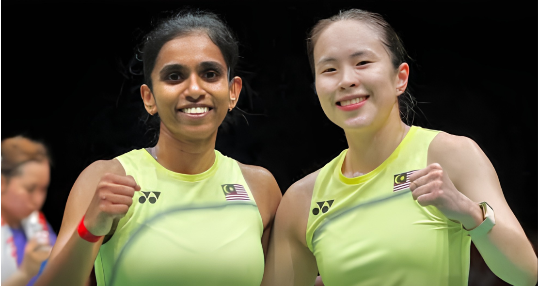 M. Thinaah and Pearly Tan smile and celebrate with fist pumps in their lime green Malaysian jerseys during the Asian Games.