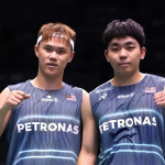 Tee Kai Wun and Yap Roy King celebrate with fist pumps in their navy blue Petronas Malaysian national team jerseys.
