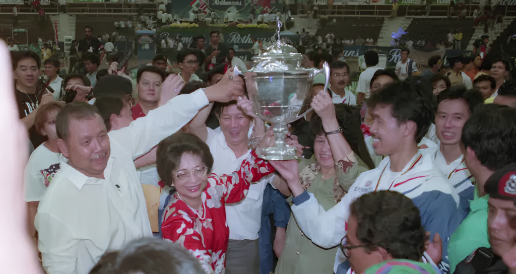 Dr Siti Hasmah Mohamad Ali lifts the 1992 Thomas Cup trophy alongside team captain Razif Sidek and the Malaysian squad.