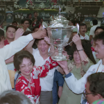Dr Siti Hasmah Mohamad Ali lifts the 1992 Thomas Cup trophy alongside team captain Razif Sidek and the Malaysian squad.