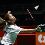 Cheng Su Yin extends her racket to play a net return while Jimmy Wong guards the rear court in their white jerseys.