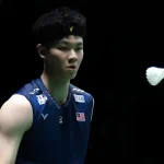Lee Zii Jia tracks the shuttlecock with razor sharp focus in his navy blue Malaysian national jersey and black headband.