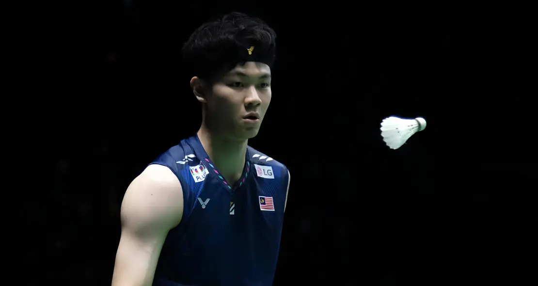 Lee Zii Jia tracks the shuttlecock with razor sharp focus in his navy blue Malaysian national jersey and black headband.