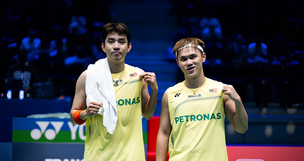 Man Wei Chong and Tee Kai Wun celebrate on court in their yellow Petronas jerseys during the French Open.