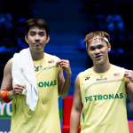 Man Wei Chong and Tee Kai Wun celebrate on court in their yellow Petronas jerseys during the French Open.