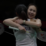 Pearly Tan embraces M. Thinaah in a warm celebratory hug on court with rackets in hand.