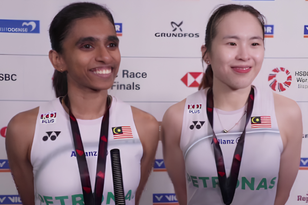 M. Thinaah and Pearly Tan smile during a media interview in their white Petronas jerseys at the Denmark Open.