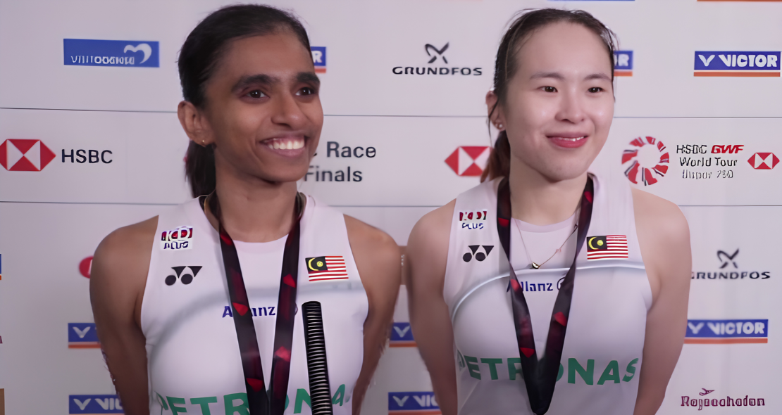 M. Thinaah and Pearly Tan smile during a media interview in their white Petronas jerseys at the Denmark Open.