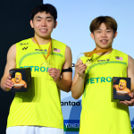 Yap Roy King and Aaron Tai smile on the podium holding their gold medals and tournament gifts at the Arctic Open.